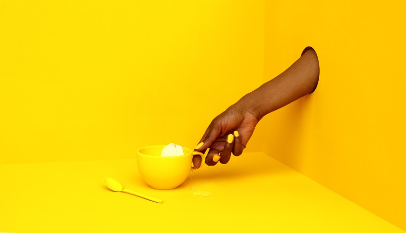 Cup of tea on yellow background