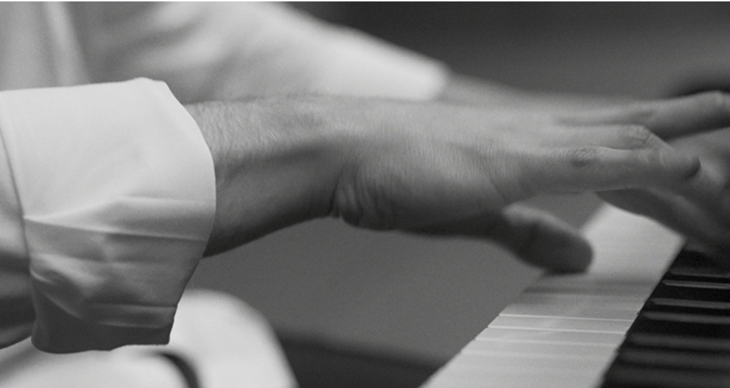 Man playing a piano with his right hand